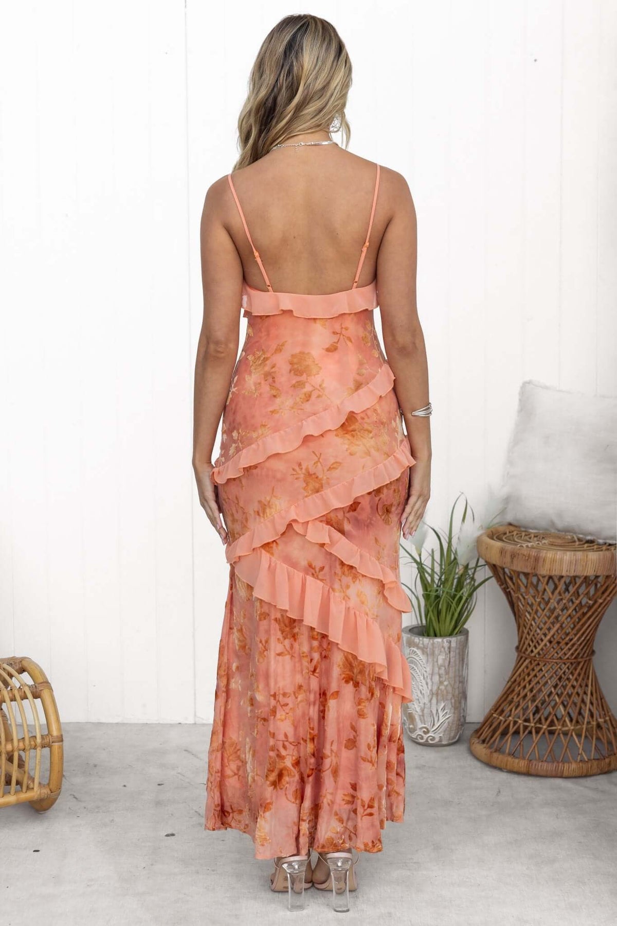 Back view of the Istelle Maxi Dress featuring ruffles, adjustable straps, and floral pattern.