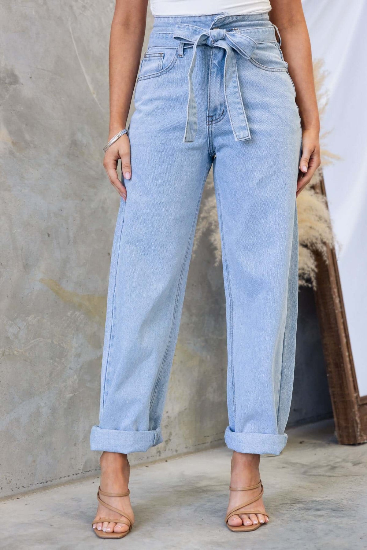 Henderson Jeans featuring a mid-high waist, paper-bag style with a removable belt, styled with rolled cuffs.