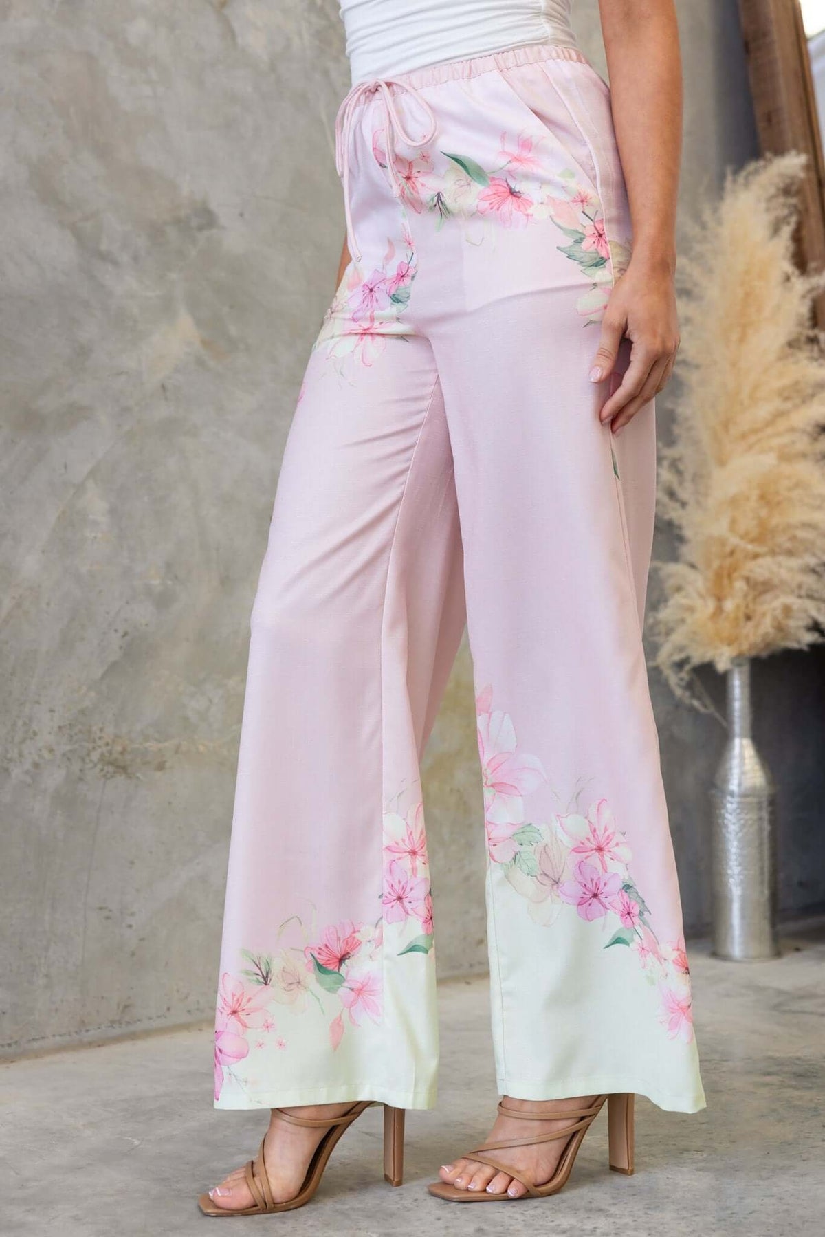 Pink floral Avalon pants with elastic waistband, perfect for casual outfits and stylish comfort.