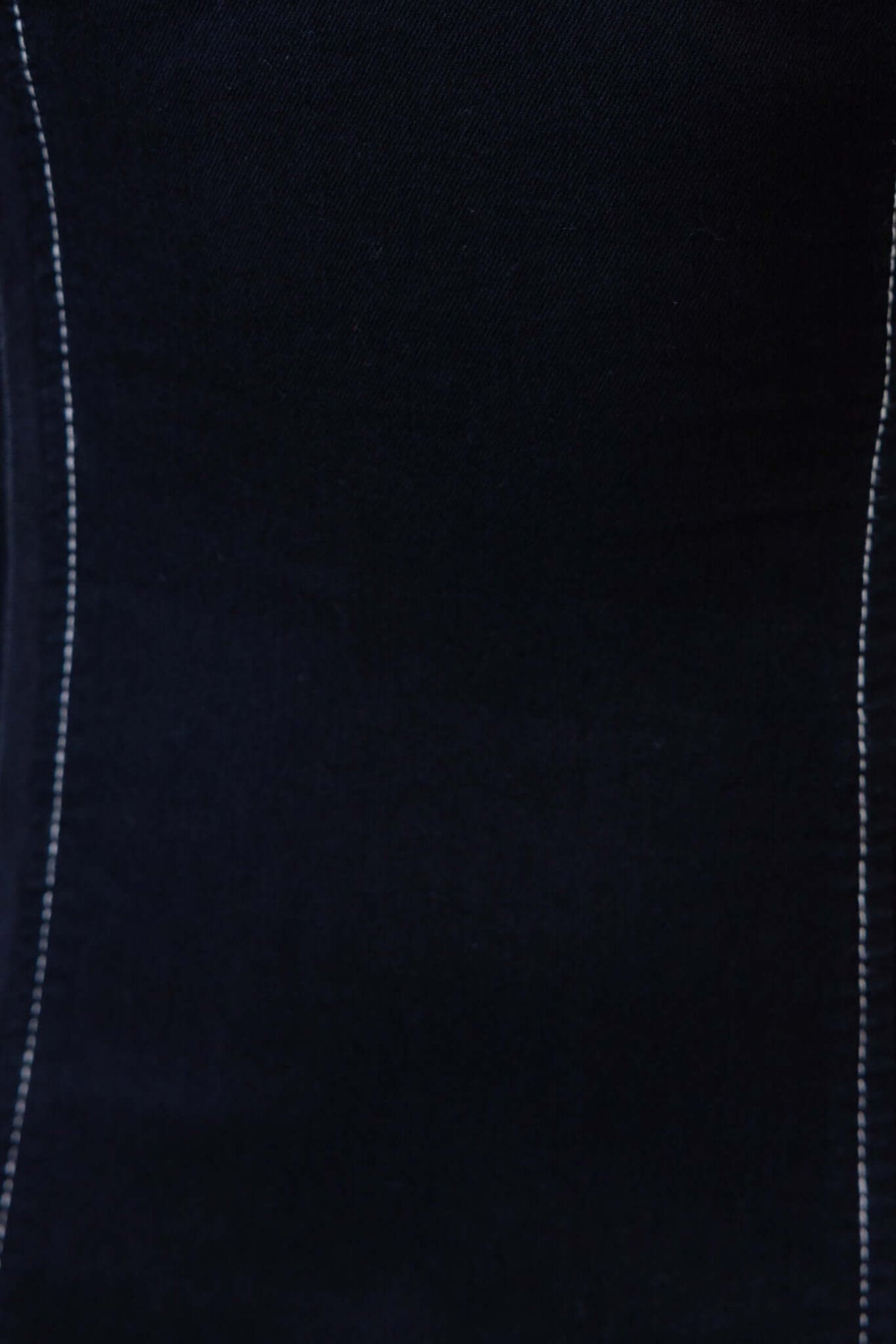 Close-up of black denim fabric with white stitching, showcasing the texture for the Beau Denim Maxi Dress.
