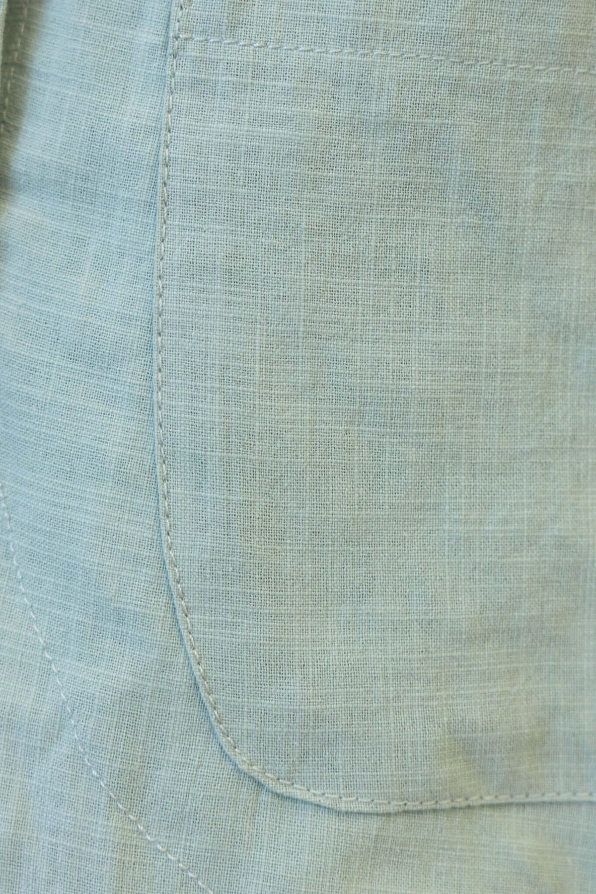 Close-up of the pocket detail on Bexley shorts in a light cotton fabric, showcasing a soft texture and tailored finish.
