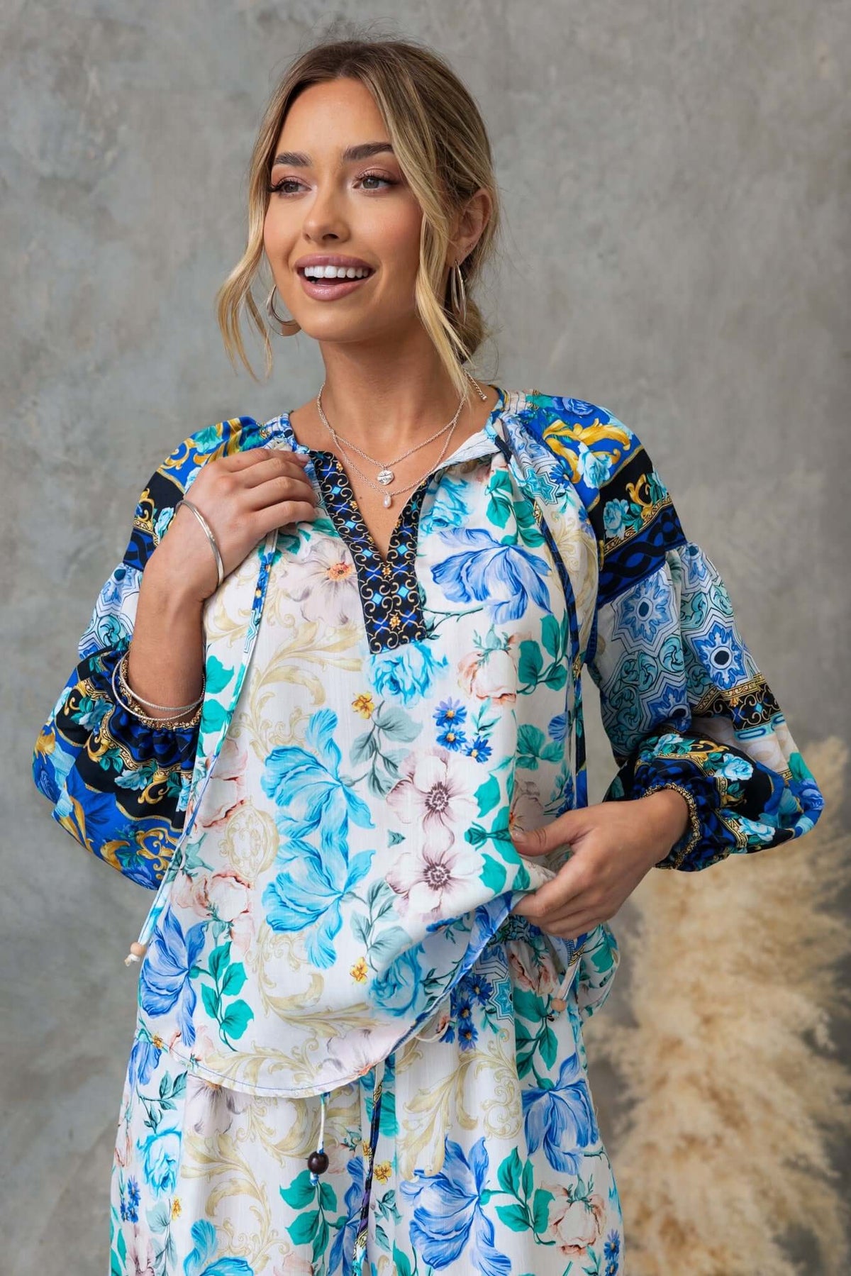 Floral print Valora Top featuring V-neckline and tie detail, styled with a relaxed fit for a chic look.