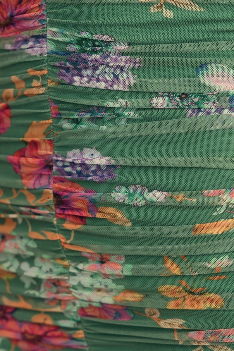 Close-up of the green mesh overlay of the Zachia Maxi Dress featuring vibrant floral ruching details.