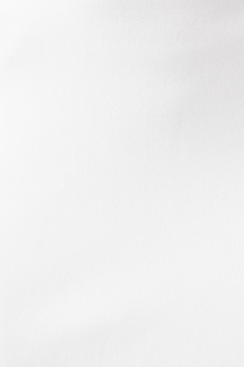Close-up of smooth white fabric, showcasing the stretch material used in the Heads Turn Maxi Dress.