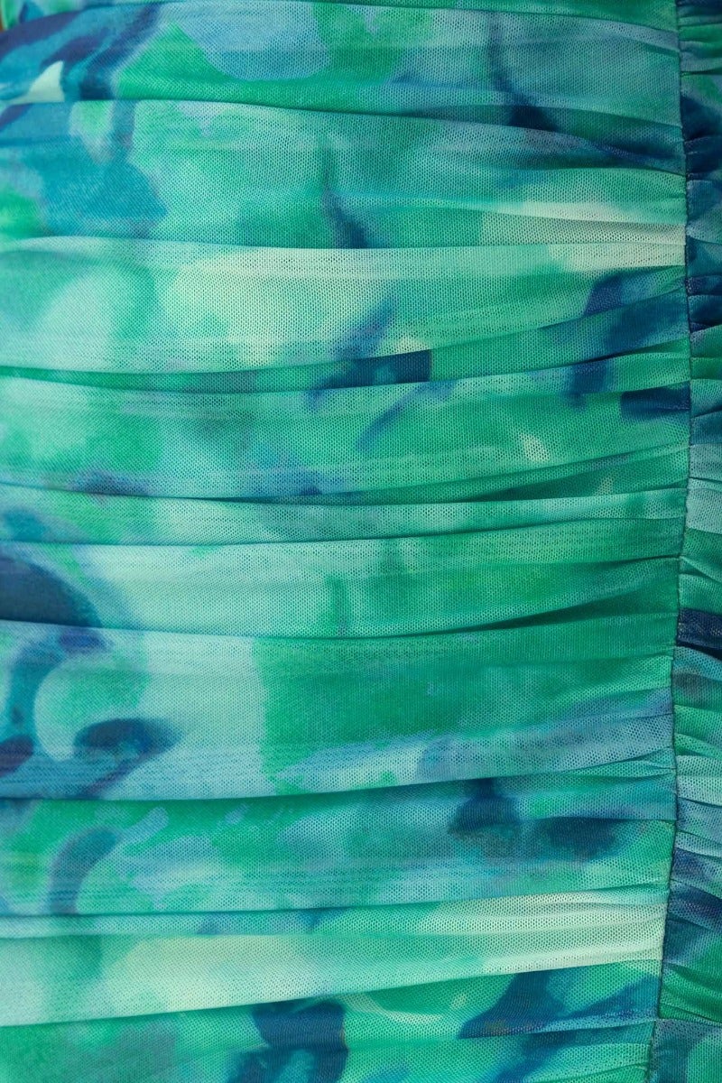 Close-up of the abstract print fabric featuring ruched details in vibrant green hues for the Special Guest Maxi Dress.