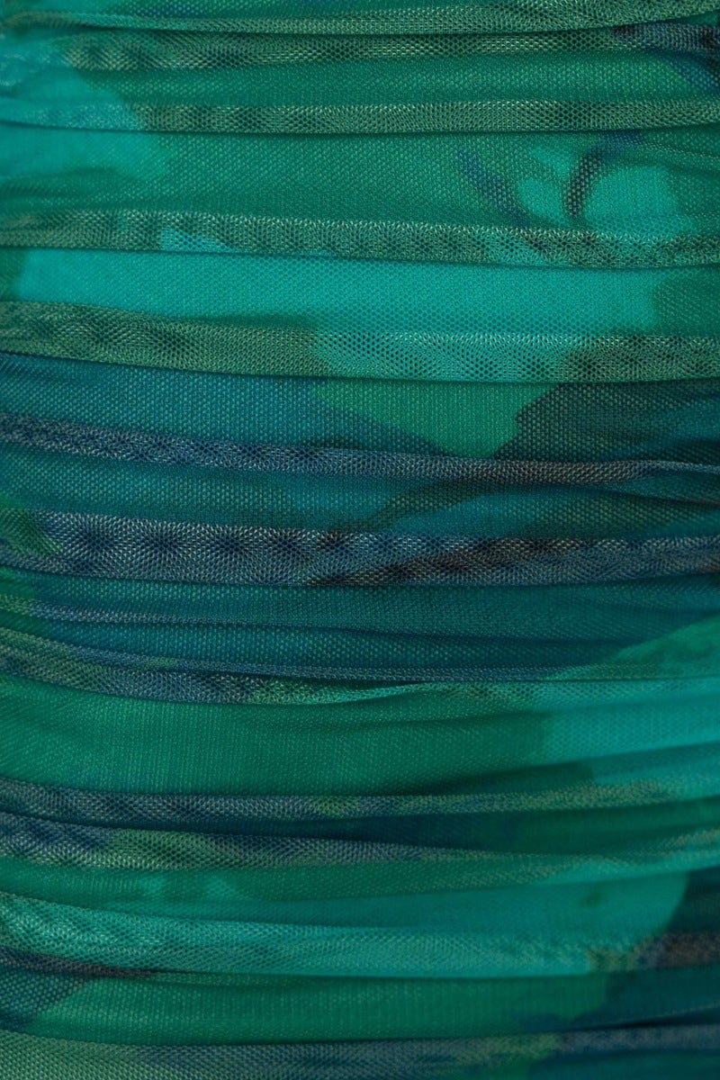 Close-up of textured green mesh fabric with ruched details, ideal for an abstract print maxi dress.