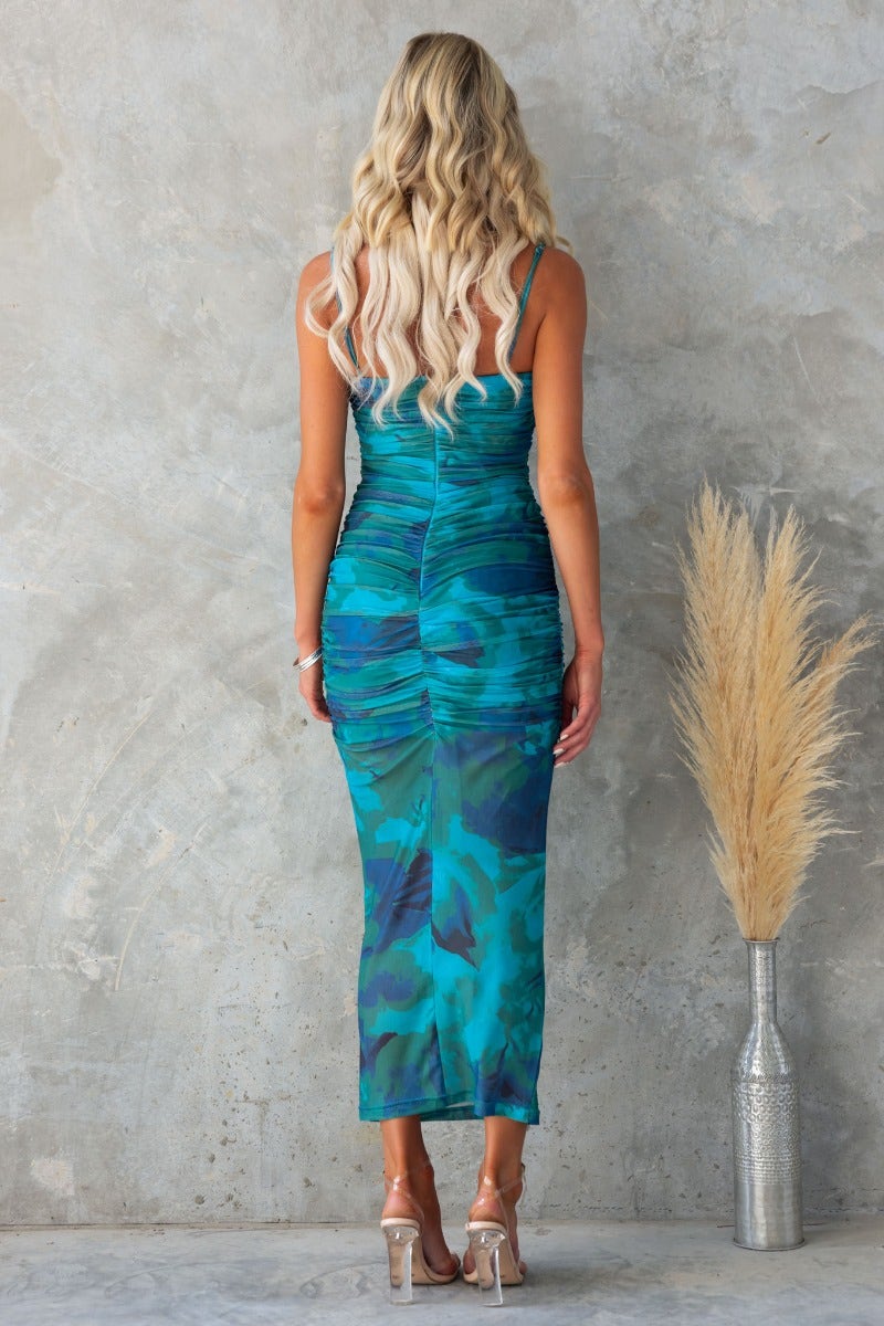 Back view of Azriel Midi Dress with mesh overlay, ruched details, and adjustable straps in vibrant teal and blue colors.