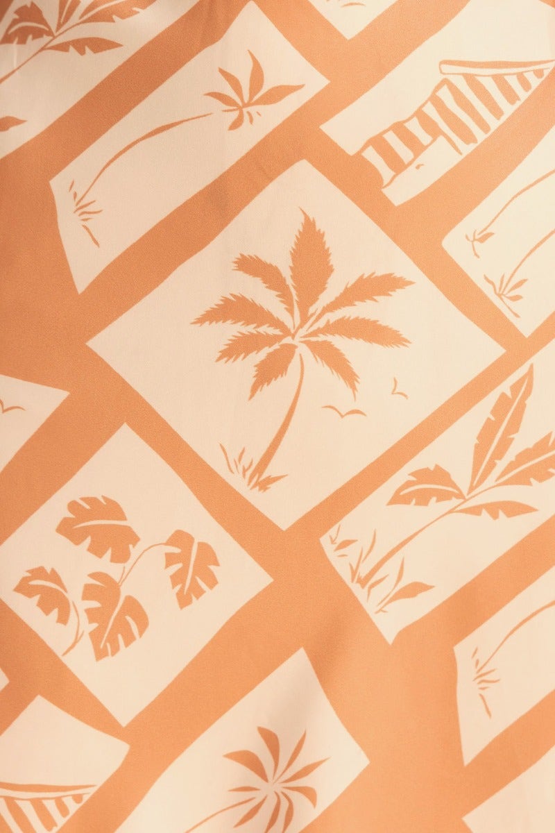 Tropical floral pattern in peach tones, featuring palm trees and leaves on a cream background.