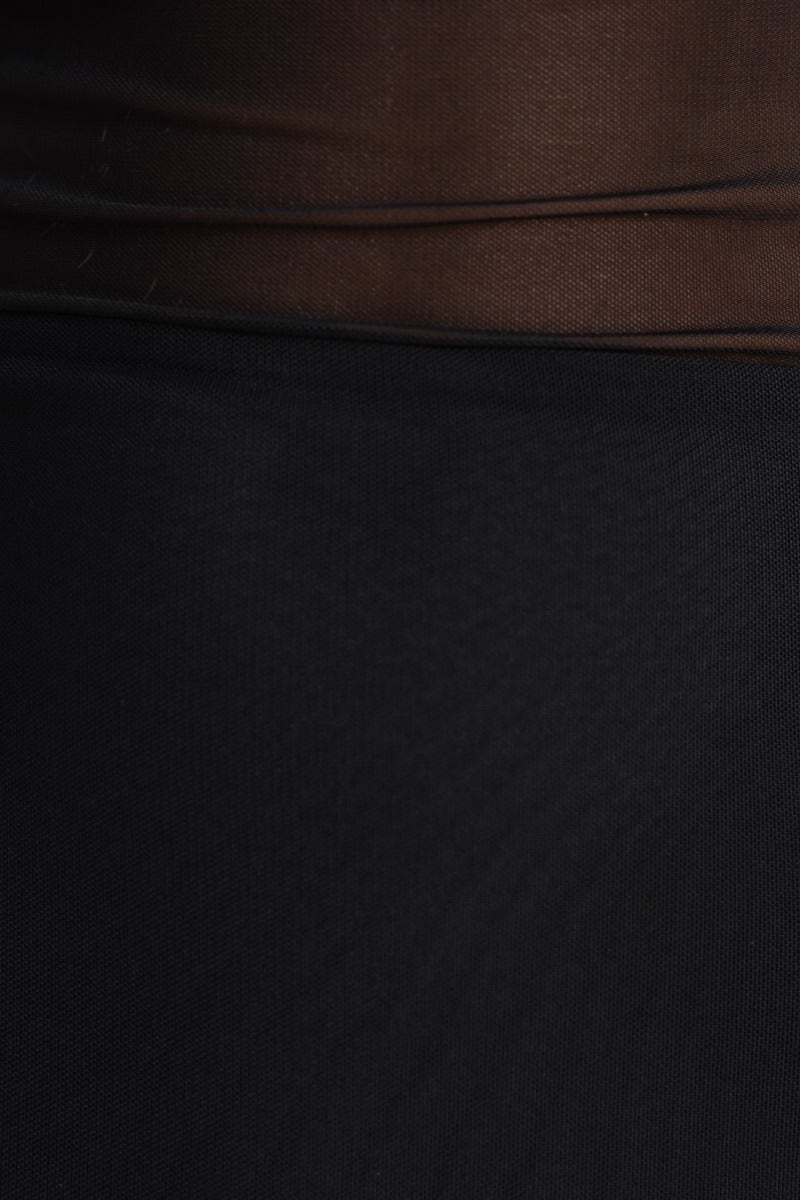 Close-up of the Lenore Maxi Dress fabric showcasing the soft black mesh overlay and fitted design.