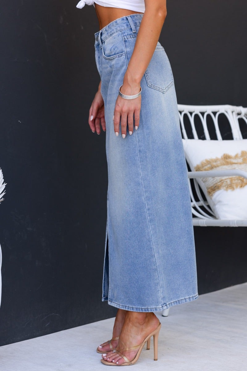Side view of Carlow Denim Maxi Skirt featuring a mid-high waist, front split, and light cotton feel.