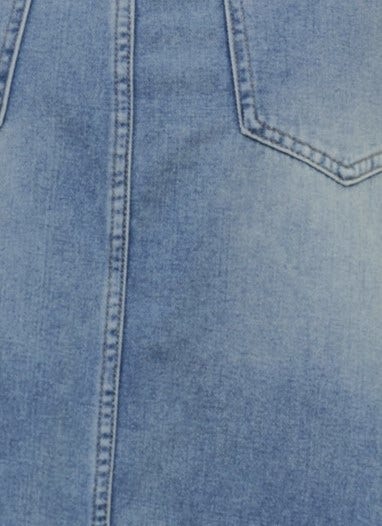 Close-up of Carlow Denim Maxi Skirt showing mid-high waist, front split, and light blue cotton fabric details.
