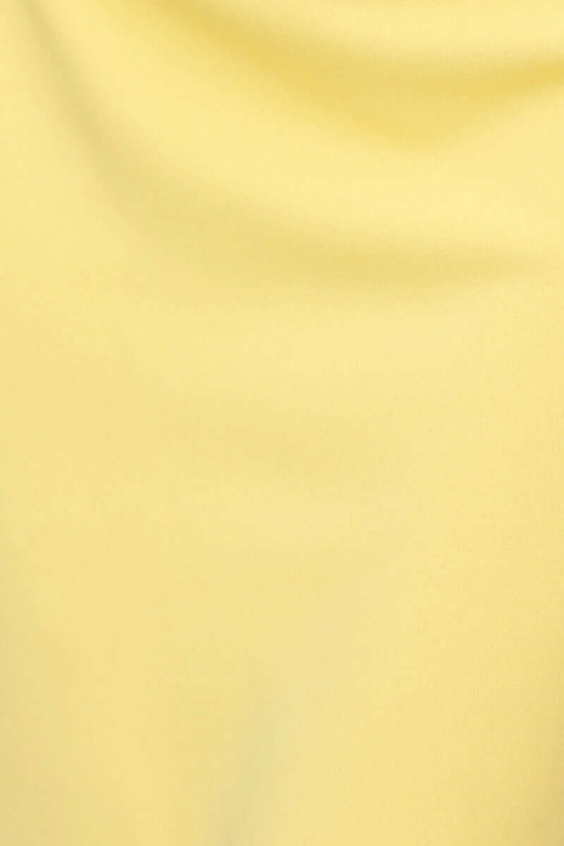 Close-up of soft, stretchy crepe-like fabric in vibrant yellow, ideal for a stylish bodycon maxi dress.