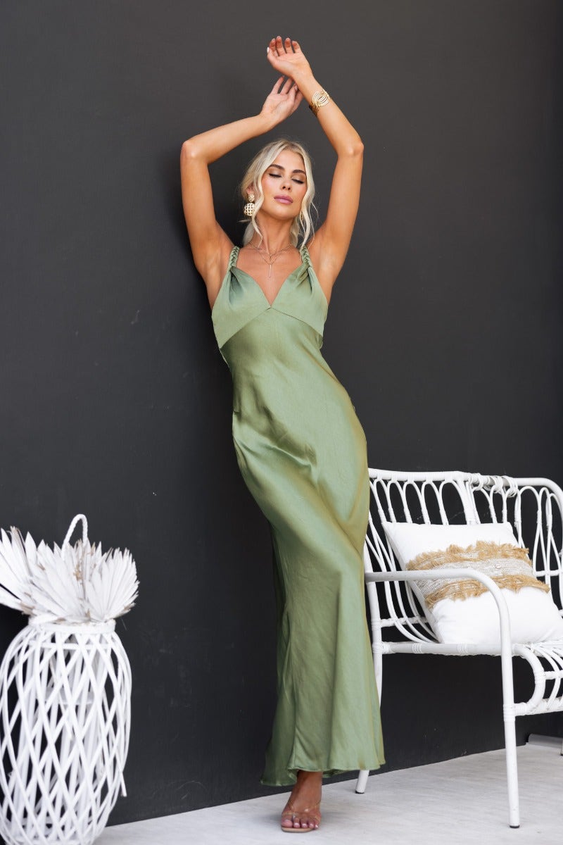 Model wearing a green satin Forest Maxi Dress with adjustable straps, featuring a stylish and elegant fit.