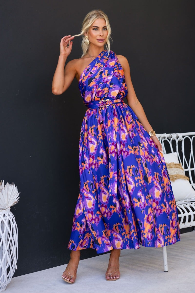 Model wearing a vibrant Ragie Maxi Dress with one-shoulder style, showcasing a multi-colour design and an elegant silhouette.