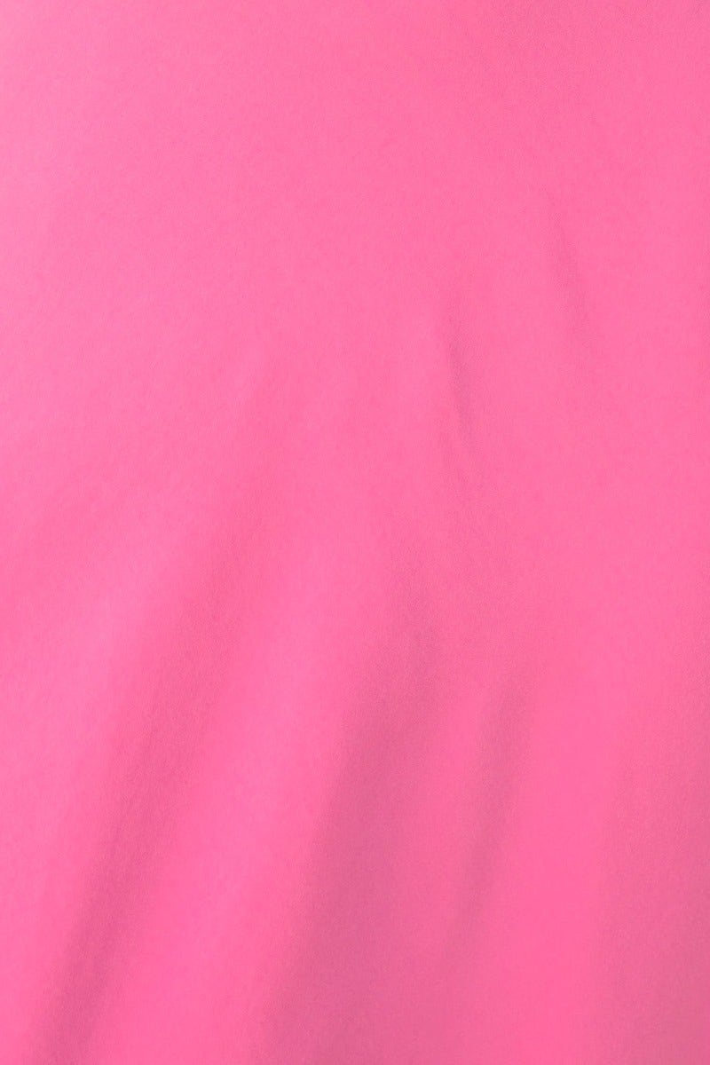 Close-up of vibrant pink fabric texture, showcasing a smooth sheen ideal for dresses and vibrant fashion apparel.