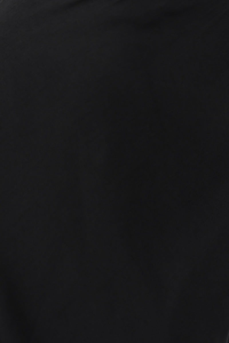 Close-up of the fabric texture of the Forbidden Love Maxi Dress in black, showcasing its slight sheen and smooth surface.