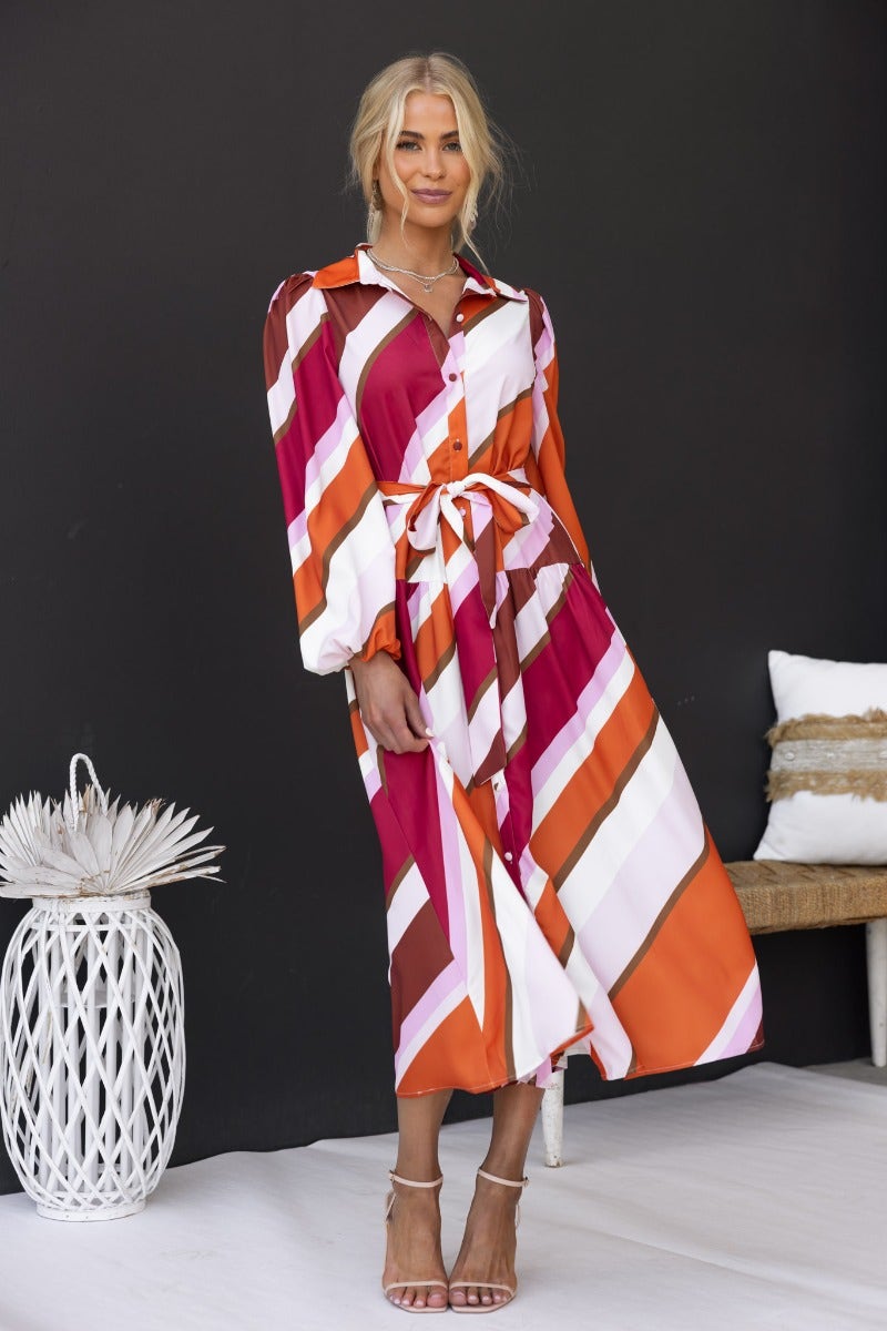 Nylah Midi Dress featuring a multi-colour print, button-up front, and removable belt, styled with elastic cuffs.