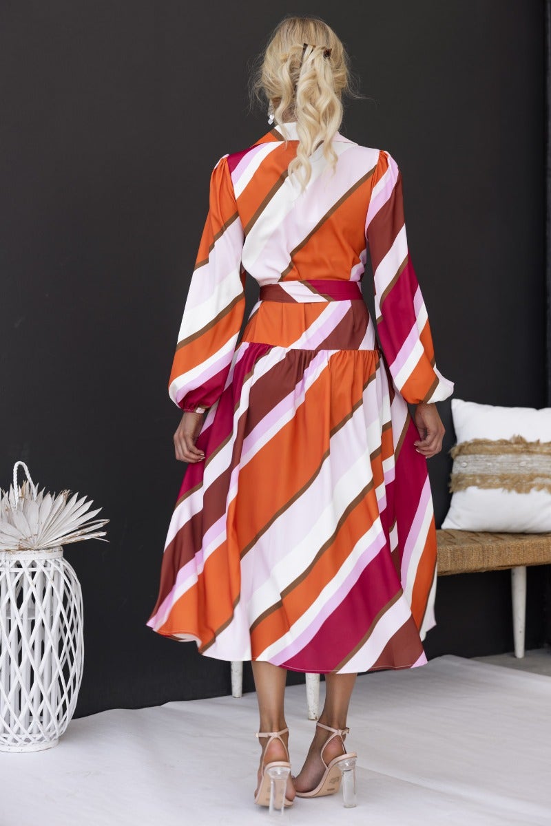 Model wearing a multi-colour striped Nylah midi dress with long sleeves and removable belt.