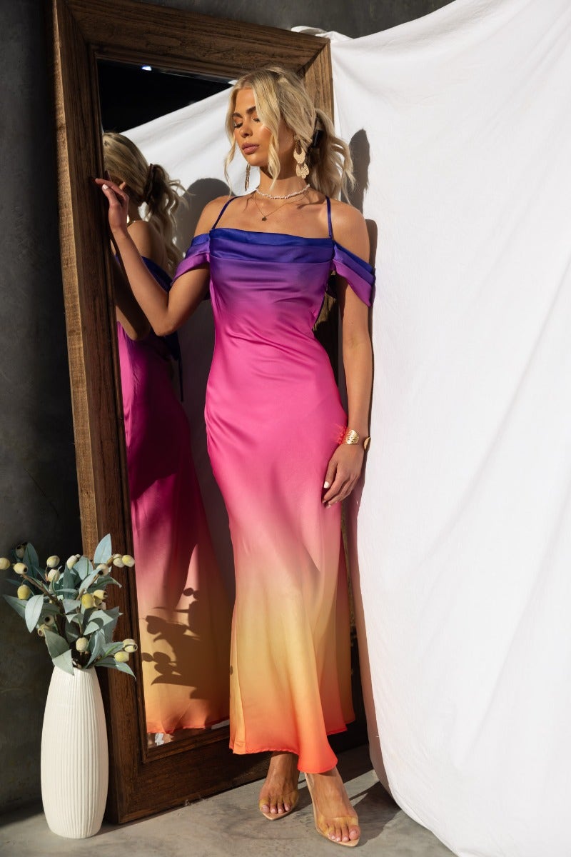Model wearing the Jiah Maxi Dress, a multi-color gradient gown with adjustable straps and cap sleeves.