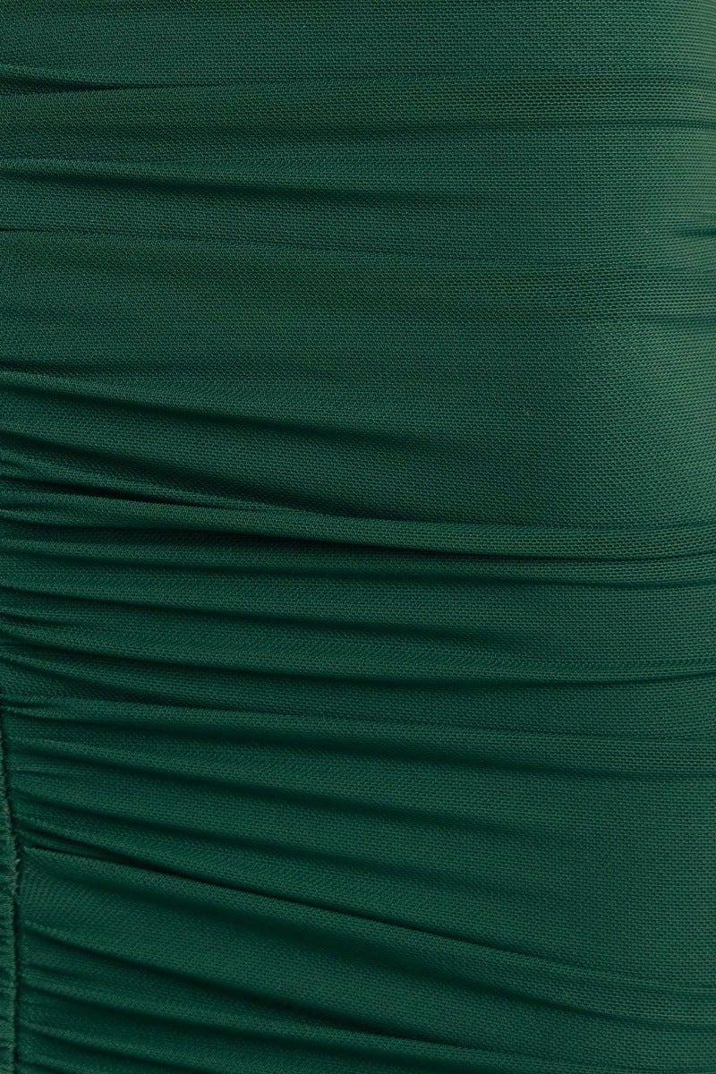Close-up of rich green fabric with ruched detailing, showcasing texture and stretch of the Rosetta Maxi Dress.
