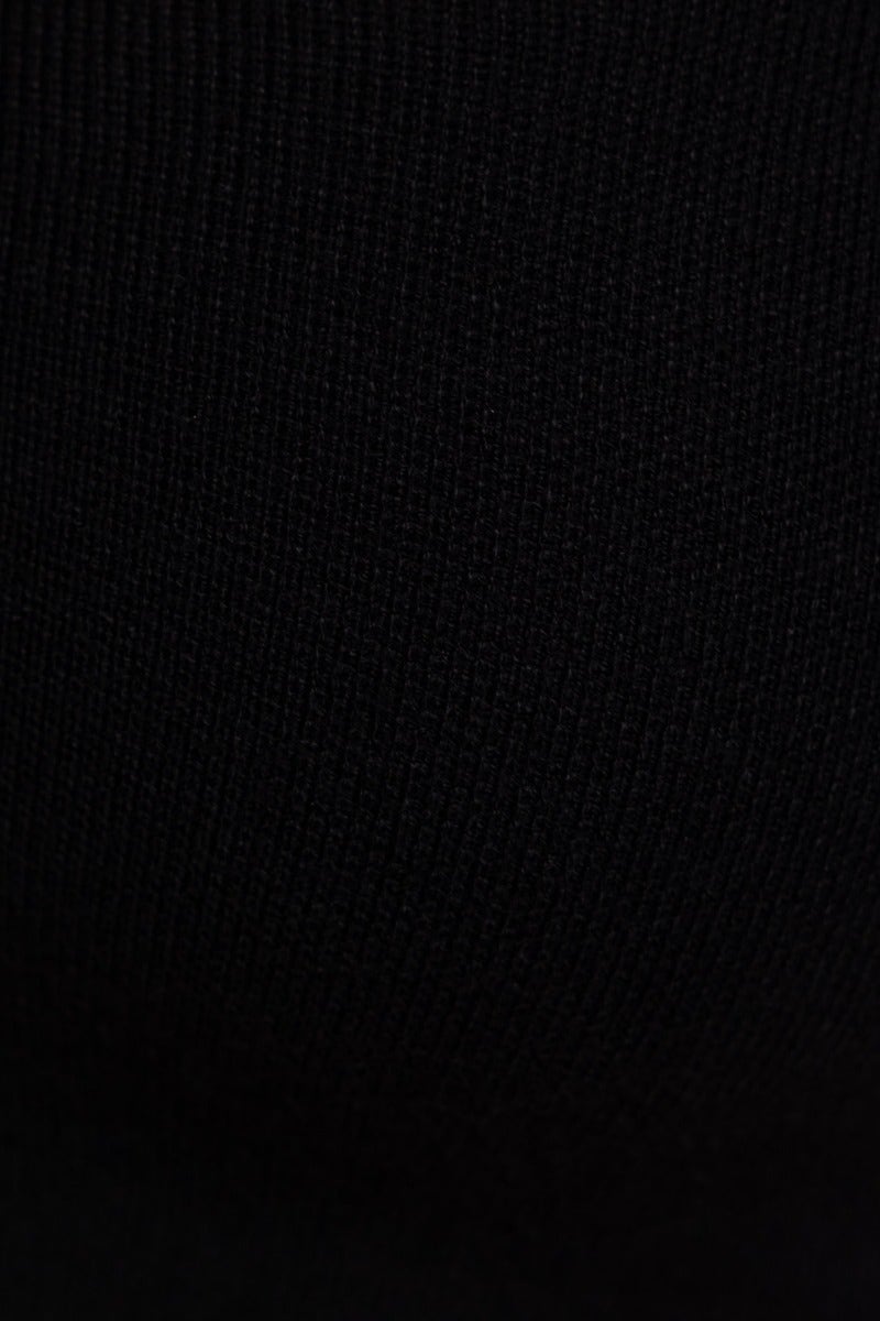Close-up of black ribbed knit material, showcasing texture for Carrie Top with a square neckline.