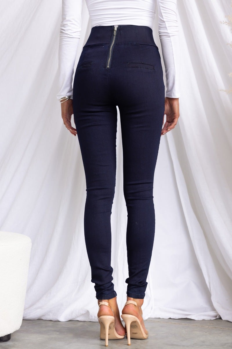 Back view of navy high-waisted pants with a zip closure, featuring a tight fit and faux pockets.