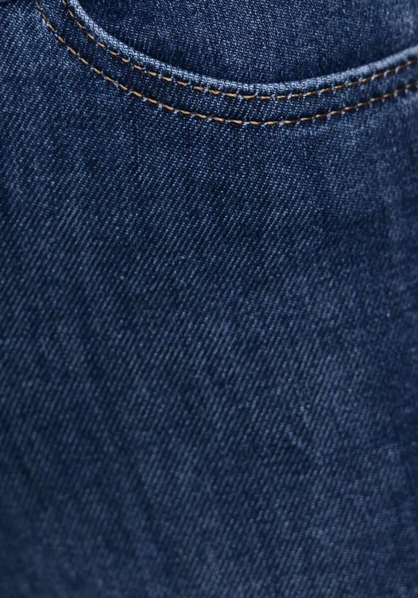 Close-up of Under Cover Jeans showcasing the denim fabric and button-up pocket design.