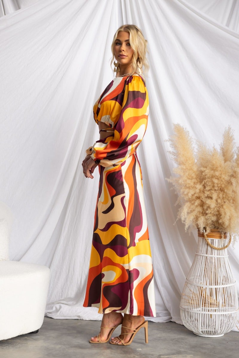 Colorful Goldie Maxi Dress featuring cut-out waist and tie detail, perfect for elegant occasions.