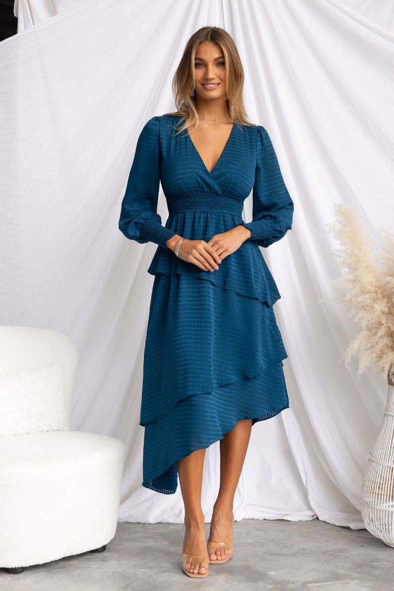 Briena Midi Dress in teal featuring V-neckline, tiered ruffle skirt, and asymmetrical hemline.