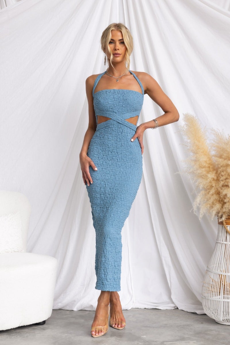 Marlini midi dress in textured blue material featuring tie neckline, cut-out waist, and back split.