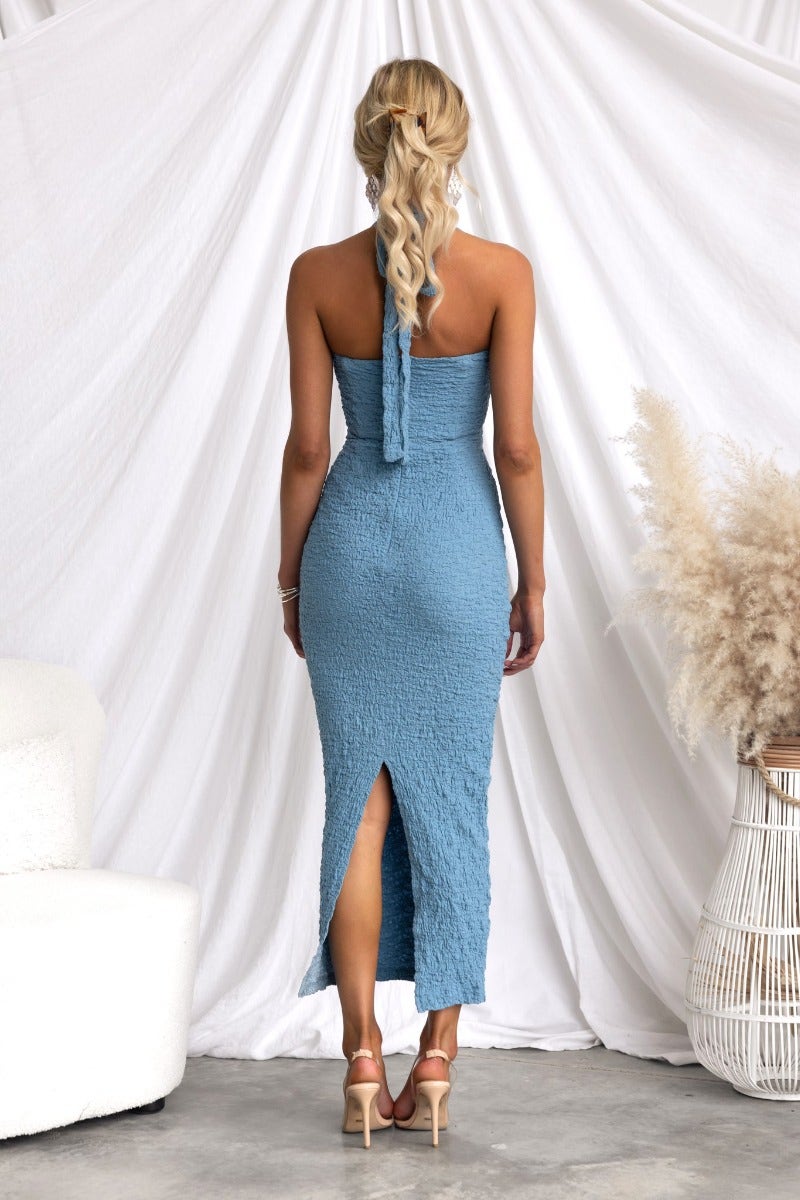 Back view of Marlini Midi Dress in blue, featuring adjustable tie neckline and back split.