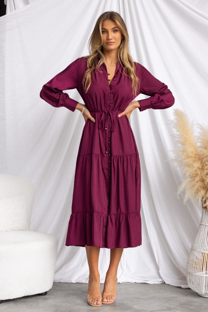 Exquisite midi dress in burgundy with collar, button-up front, and removable fabric tie, worn by a model.
