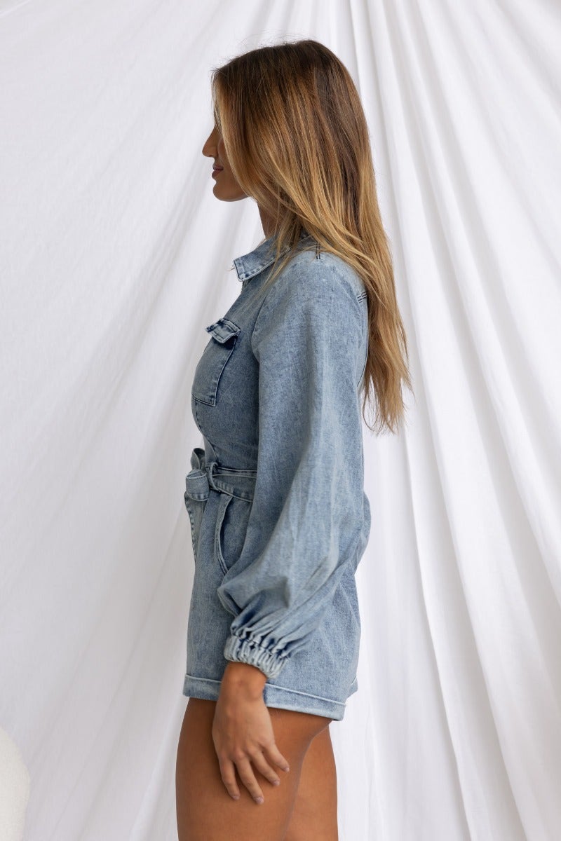 Model showcasing Rover Denim Playsuit with zip-up front, elastic cuffs, and removable belt against a white backdrop.