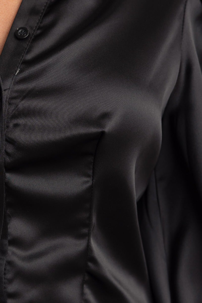 Close-up of black satin Iva Top featuring a button-up front and soft fabric texture. Perfect for stylish casual wear.