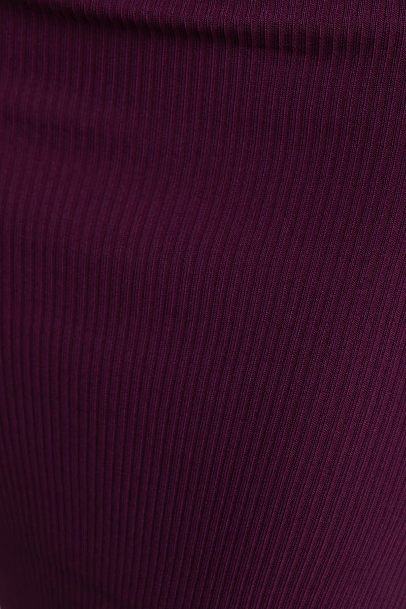 Close-up of the ribbed knit texture of the Effie Midi Dress in rich purple color.