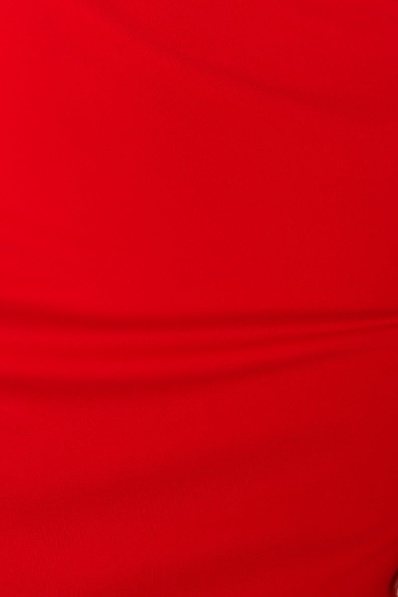 Close-up of smooth, vibrant red fabric, showcasing the texture for a stylish dress.