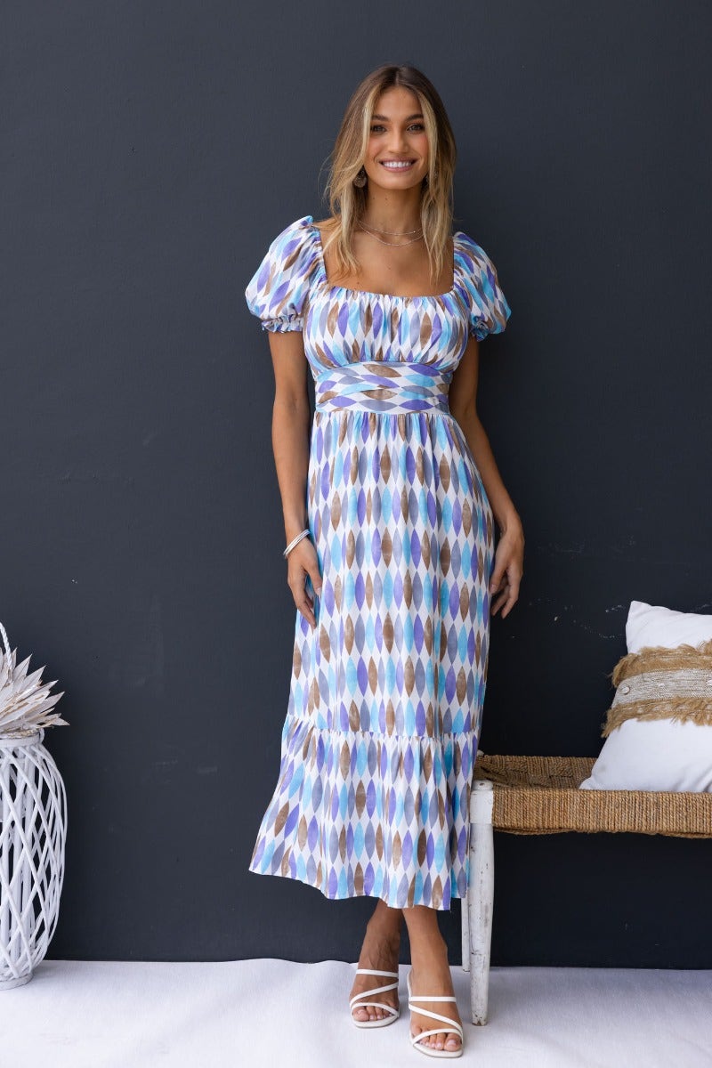 Model wearing a multi-colour printed Garland Midi Dress with a sweetheart neckline and puff sleeves.