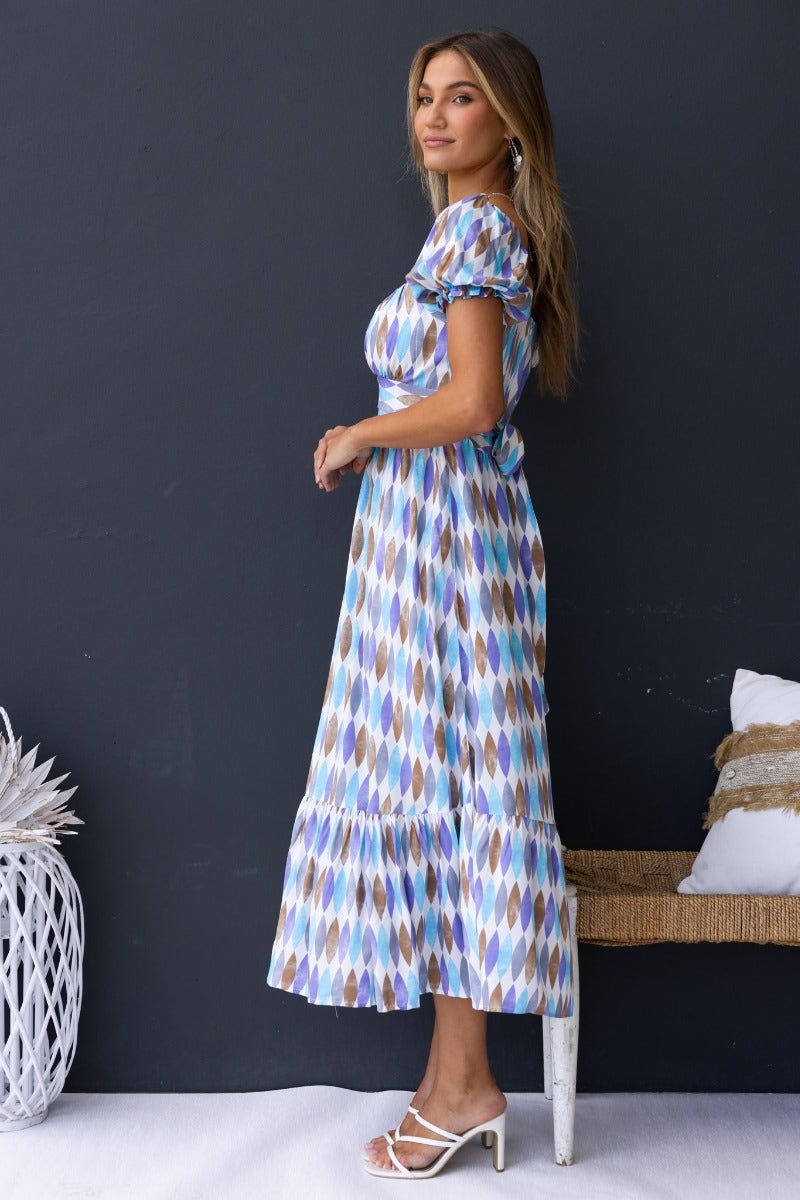 Model wearing a multi-colour print Garland Midi Dress with sweetheart neckline and elastic fittings.