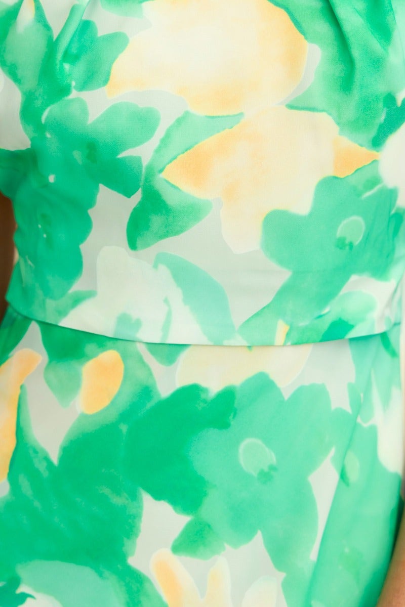 Floral print detail of Tangelo Maxi Dress in shades of green and yellow, featuring a vibrant watercolor design.