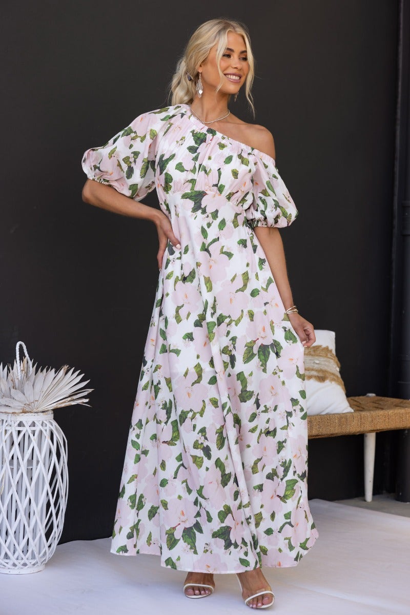 Model wearing Zonnie floral print maxi dress with off-shoulder neckline and puff sleeves, styled in an outdoor setting.