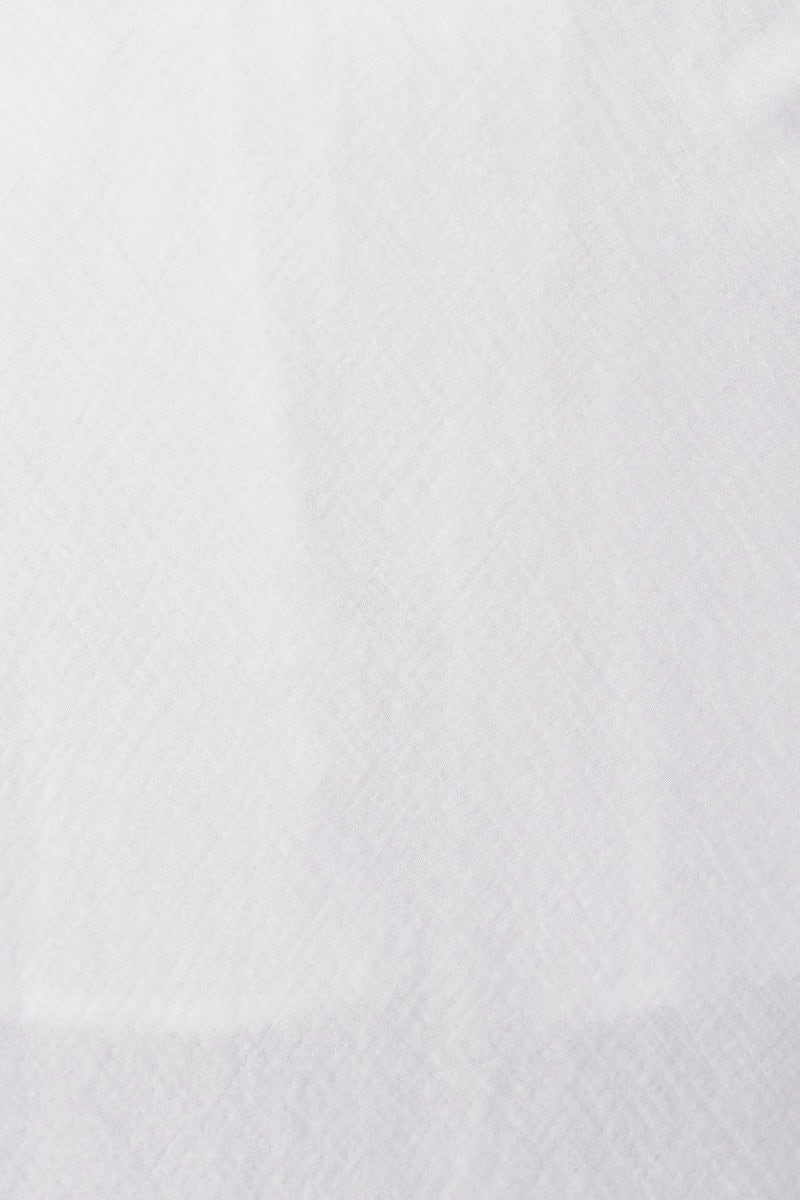 Close-up of textured white fabric used in the Gia Maxi Dress, showcasing its softness and quality material.