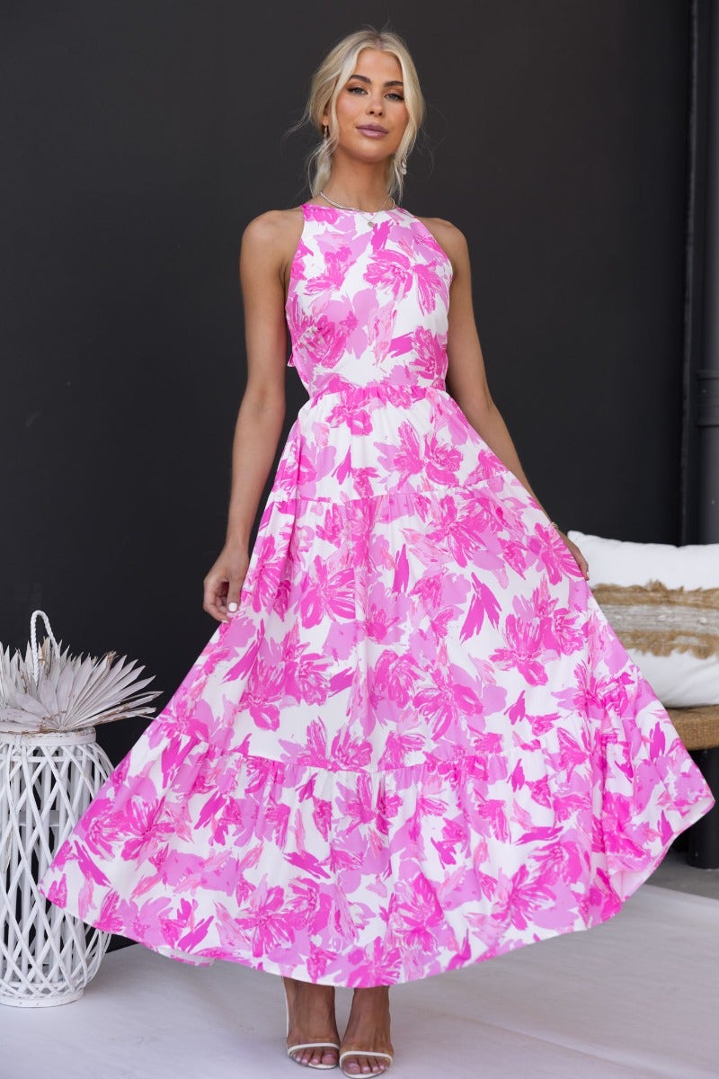 Bursa Maxi Dress featuring pink floral print, adjustable straps, tie back detail, and flowing silhouette.