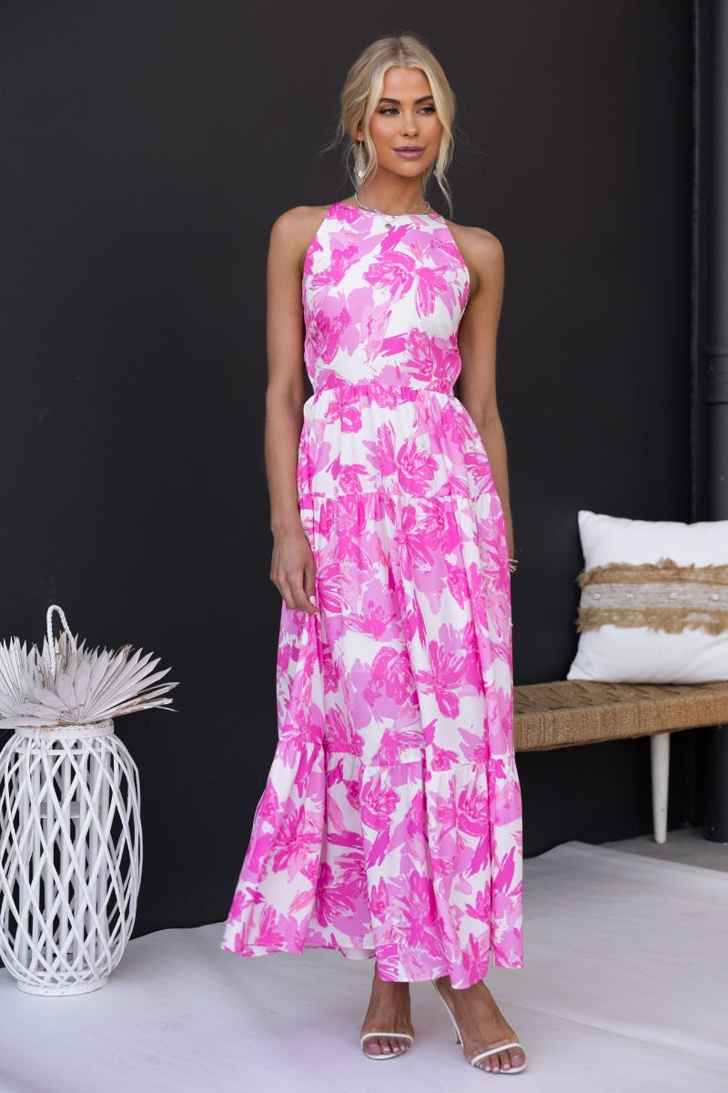 Floral print pink Bursa Maxi Dress with adjustable straps and tie detail at the back, modeled elegantly.