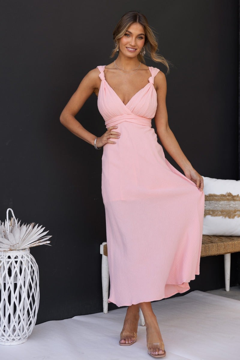 Gia Maxi Dress in pink, featuring textured material, tie details, and a flattering fit for summer occasions.