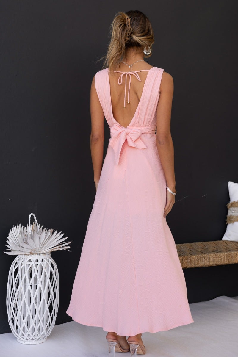 Gia Maxi Dress in soft pink with tie back detail, featuring a flowing silhouette and textured fabric, perfect for summer.