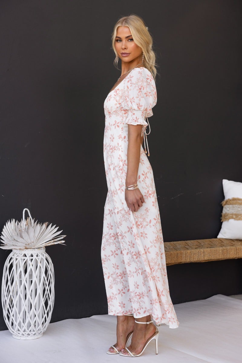 Side view of the Have A Moment Maxi Dress featuring floral print, elastic cuffs, and an open back tie detail.