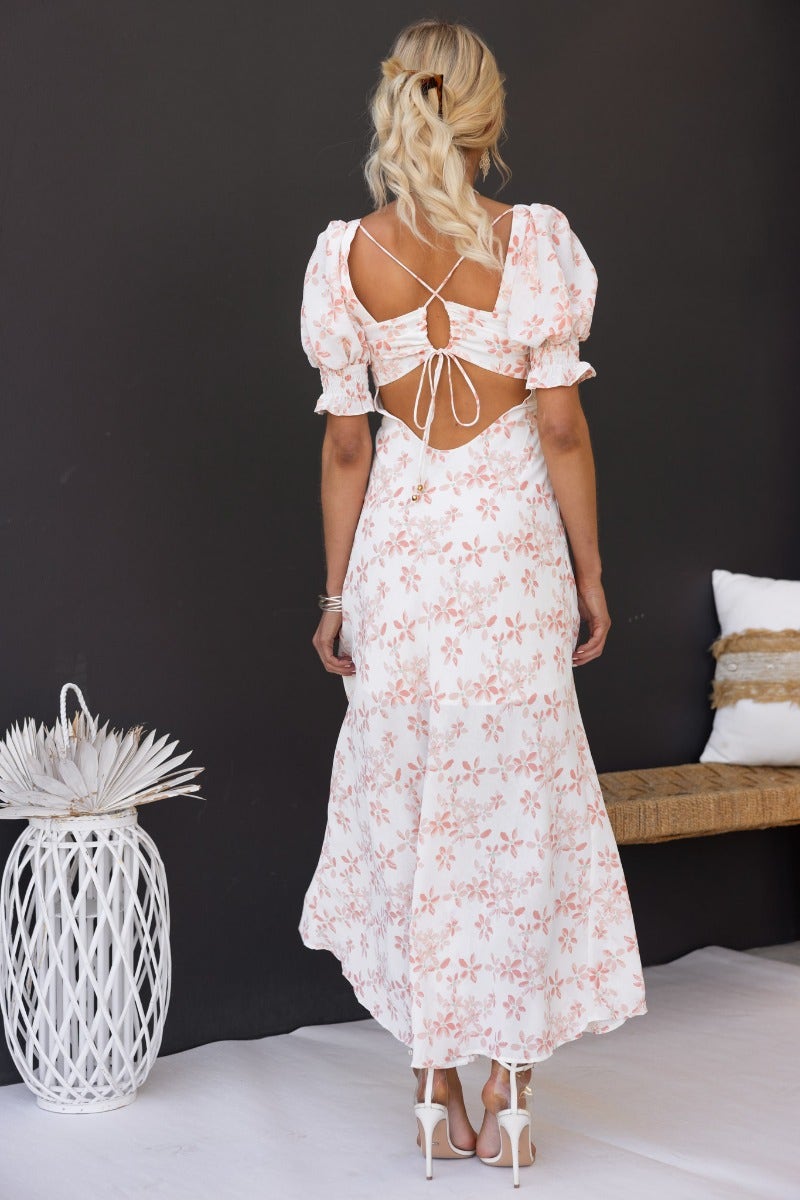 Back view of the Have A Moment Maxi Dress featuring floral print, open back, and elastic-cuffed sleeves.