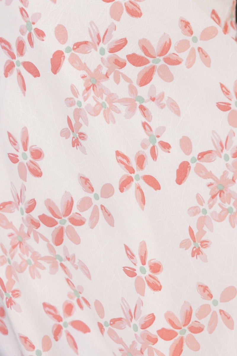 Floral print detail featuring pink and coral blossoms on a white background, showcasing the design of the Have A Moment Maxi Dress.