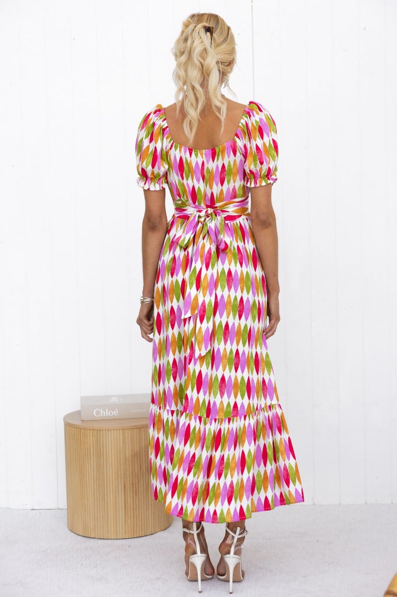 Garland Midi Dress with colorful print, sweetheart neckline, and fabric tie, model shown from back.