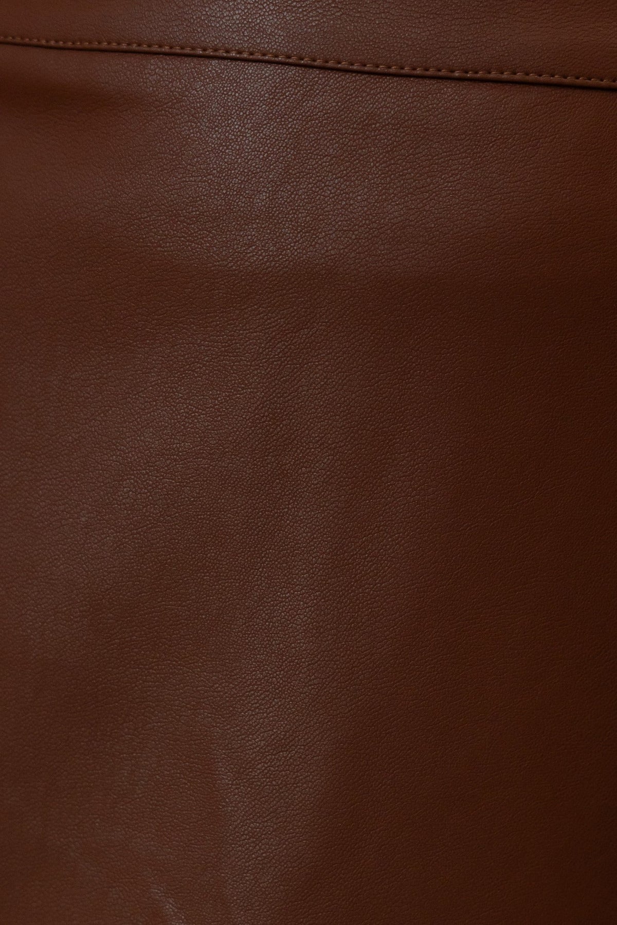 Close-up of a faux leather brown maxi skirt showing the smooth texture and mid-high waist fit.